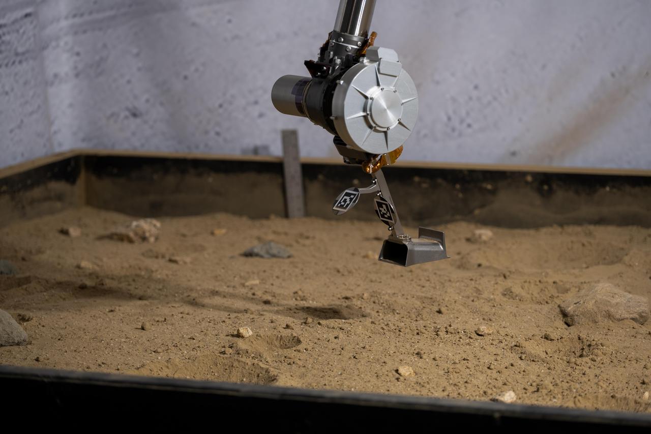 Titanium 3D-printed scoop on a robotic arm